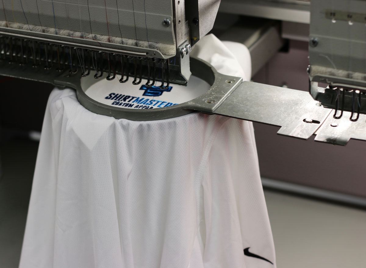 Shirtmasters’ own logo being stitched on an embroidery machine